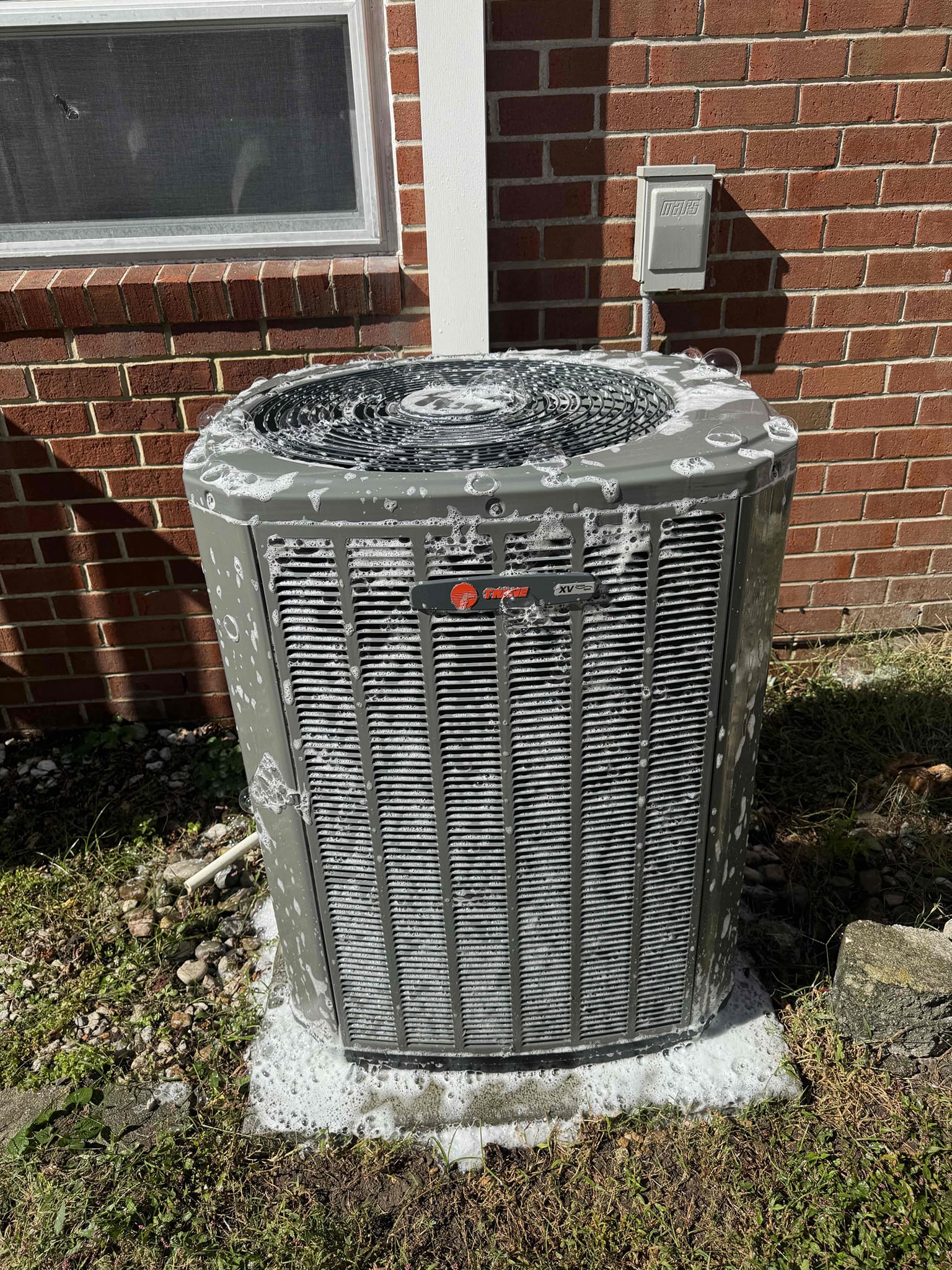 Technician performing HVAC maintenance and cleaning